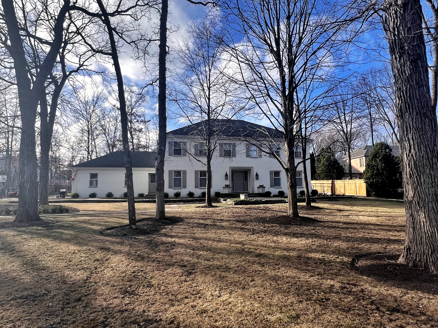 a front view of residential houses with yard and trees