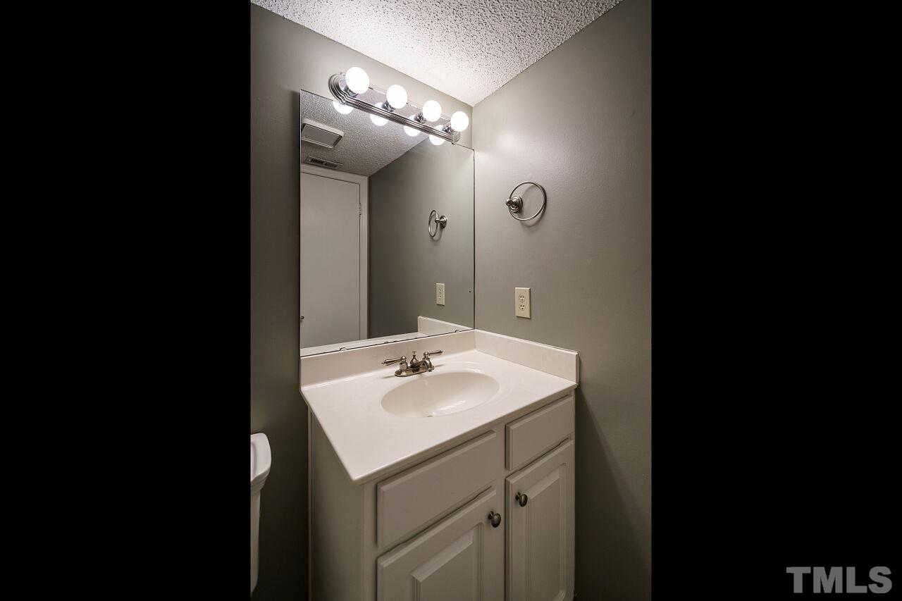 7906 Falcon Rest Circle Raleigh, NC 27615 - Photo 11 of 20 a bathroom with a sink and a mirror