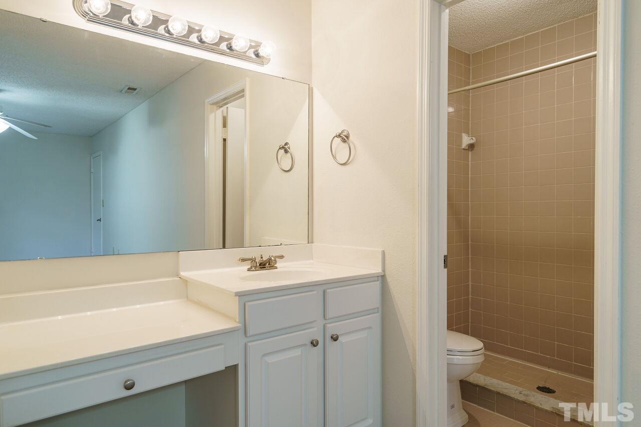 7906 Falcon Rest Circle Raleigh, NC 27615 - Photo 14 of 20 a bathroom with a sink and a mirror