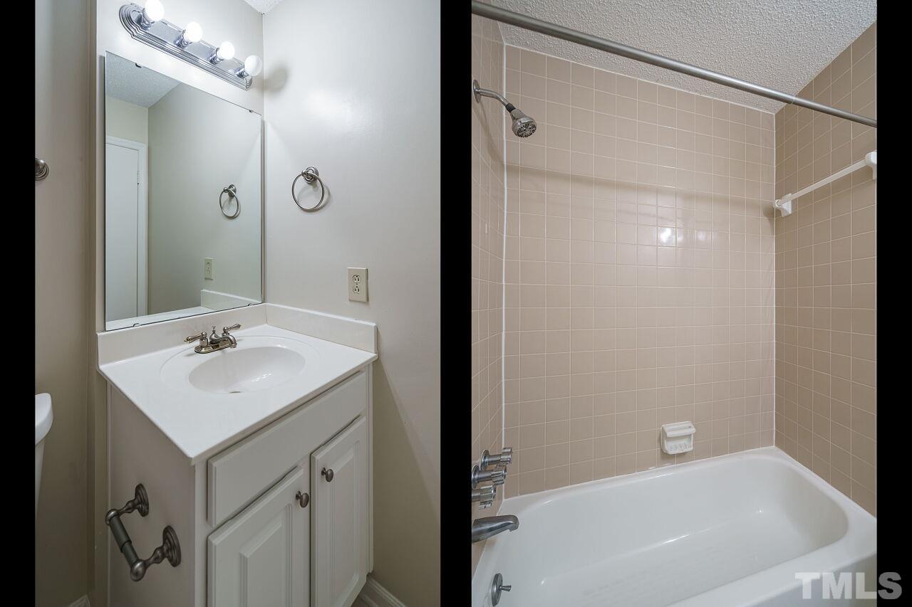 7906 Falcon Rest Circle Raleigh, NC 27615 - Photo 17 of 20 a bathroom with a tub sink vanity and a mirror