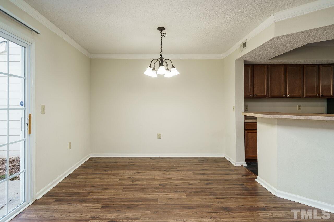 7906 Falcon Rest Circle Raleigh, NC 27615 - Photo 6 of 20 a view of a kitchen with wooden floor and a window