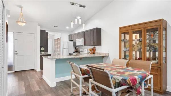 a view of a dining room with furniture and wooden floor