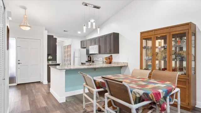 a view of a dining room with furniture and wooden floor