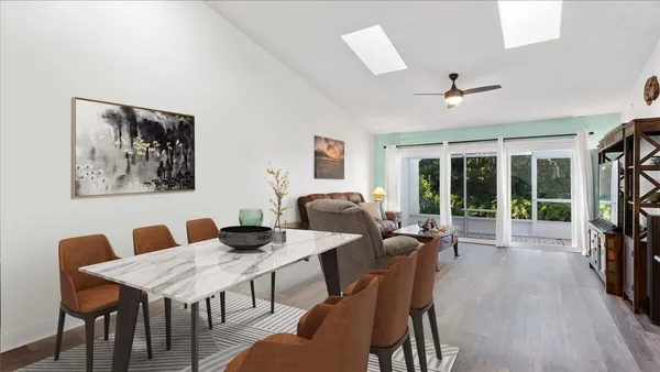 a kitchen with a table chairs refrigerator and microwave
