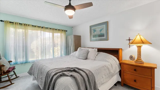 a living room with furniture kitchen view and a chandelier