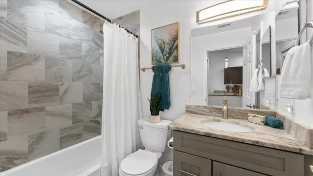 a bedroom with a bed and a dresser in it