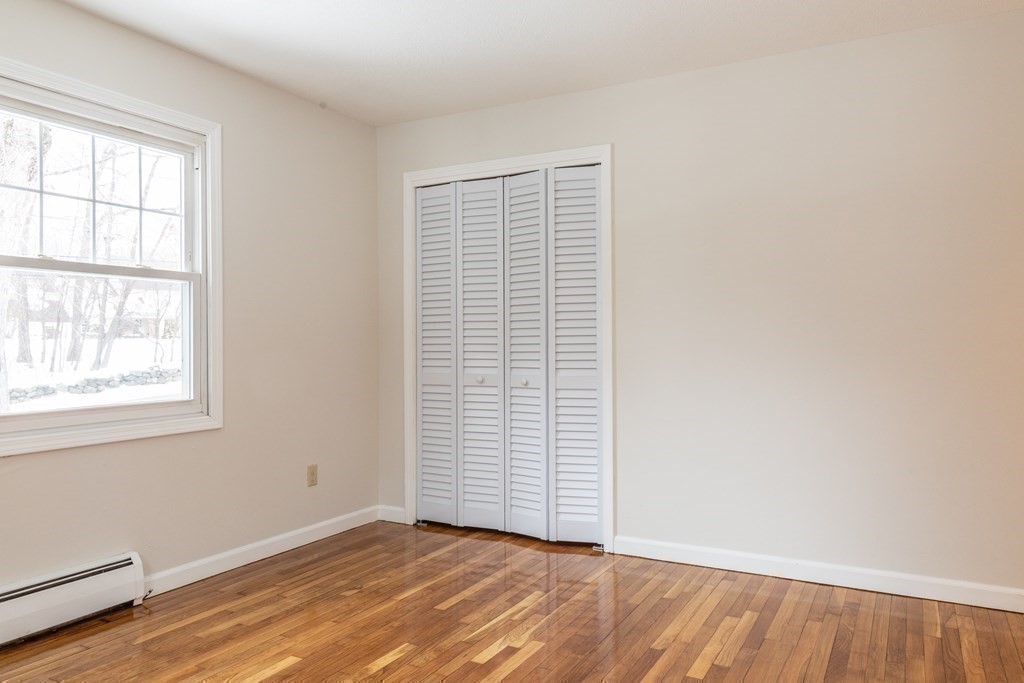 32 Paradise Lake Road Monson, MA 01057 - Photo 24 of 35 an empty room with wooden floor and windows