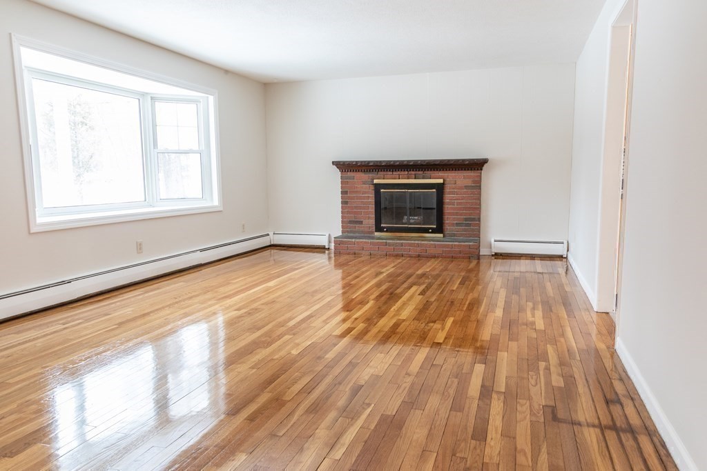 32 Paradise Lake Road Monson, MA 01057 - Photo 6 of 35 a view of an empty room with wooden floor and a window