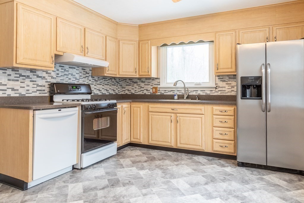 32 Paradise Lake Road Monson, MA 01057 - Photo 10 of 35 a kitchen with stainless steel appliances granite countertop a stove a sink and a refrigerator