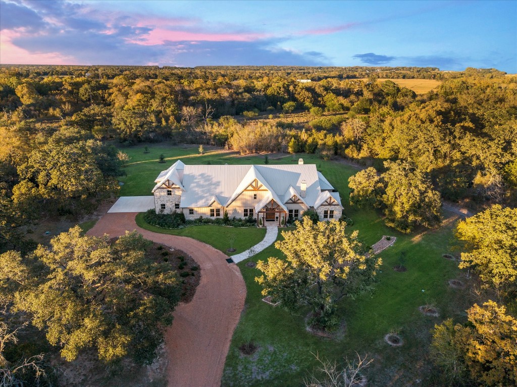 Located on desirable Hartfield Rd, Custom home is tucked behind a grove of live oaks for ultimate privacy.