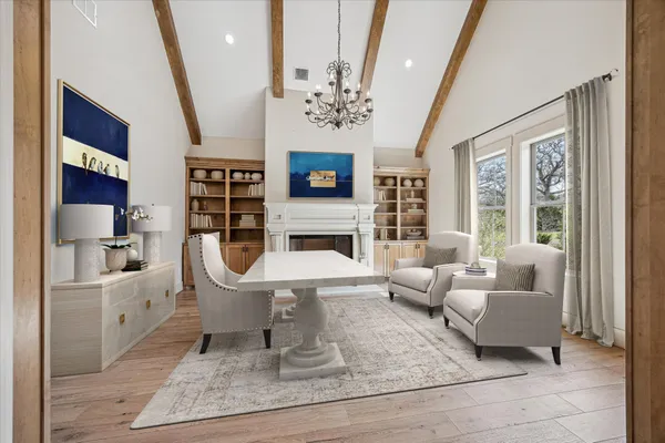 a view of living room filled with furniture and windows