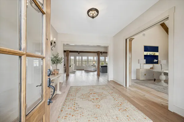a kitchen with stainless steel appliances a sink a counter top space cabinets and wooden floor