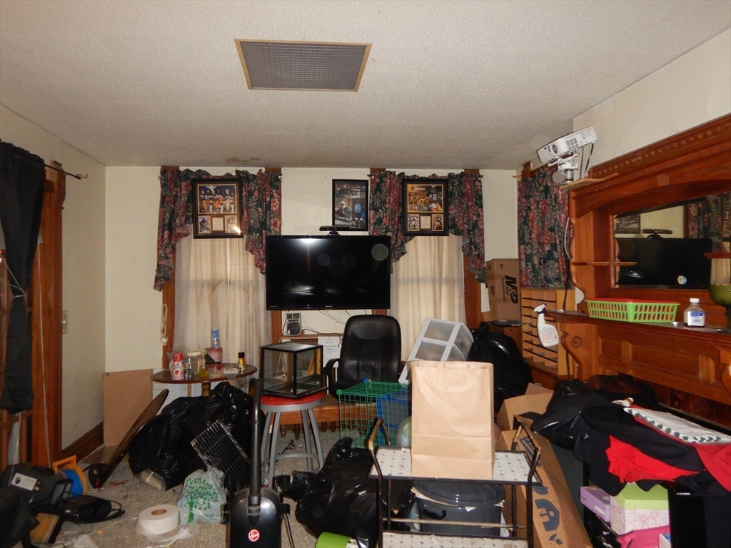 288 St James Avenue Springfield, MA 01109 - Photo 16 of 34 a room with furniture a flat screen tv and a floor to ceiling window