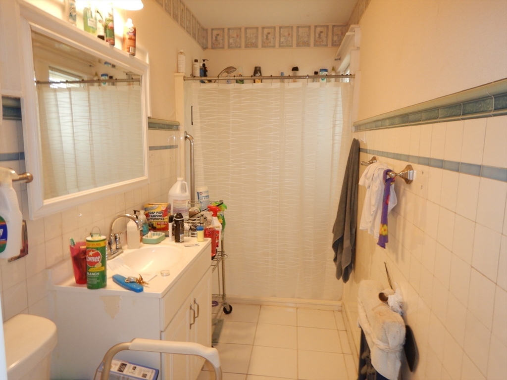 288 St James Avenue Springfield, MA 01109 - Photo 20 of 34 a bathroom with a sink mirror vanity and toilet