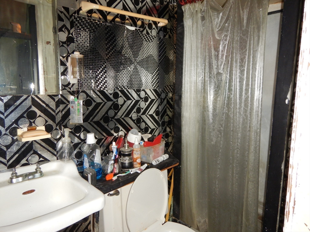 288 St James Avenue Springfield, MA 01109 - Photo 28 of 34 a bathroom with a sink and a mirror