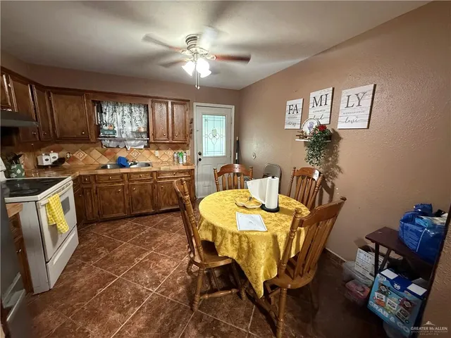 a view of a dining room with furniture and a chandelier