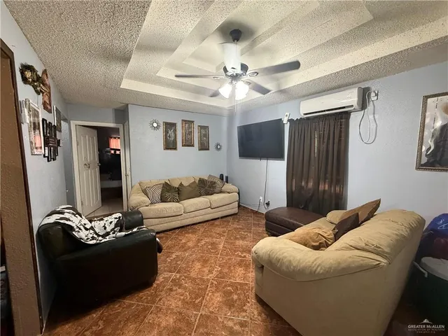 a living room with furniture ceiling fan and a rug