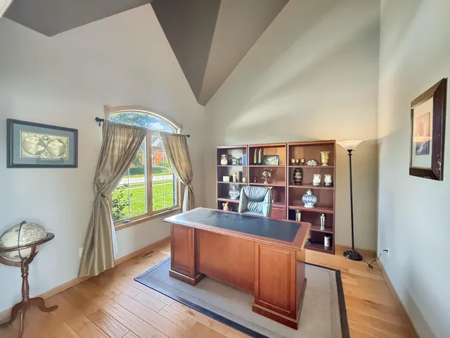 a work room with furniture and a large window