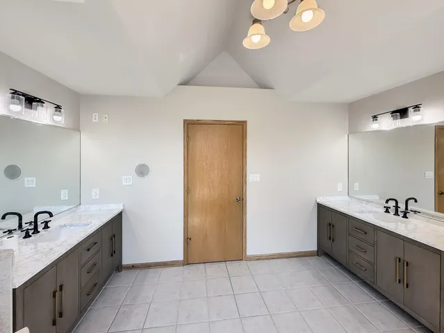 a bathroom with a double vanity sink and a mirror