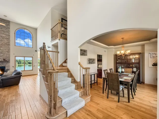 a dining room with wooden floor furniture and a floor to ceiling window