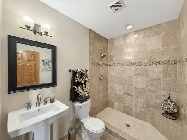 a view of a room with wooden floors and couches