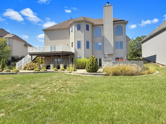 a front view of a house with lots of trees around it