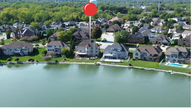 an aerial view of a house with a lake view