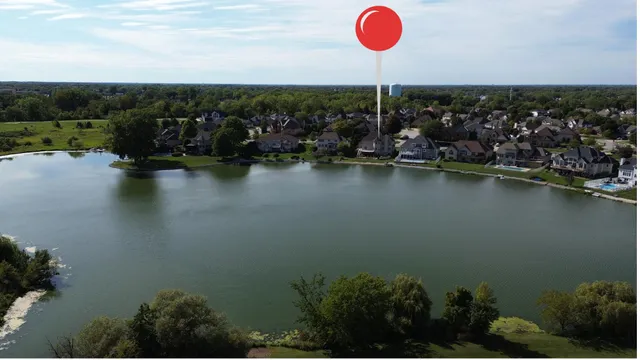an aerial view of a house with swimming pool and a yard