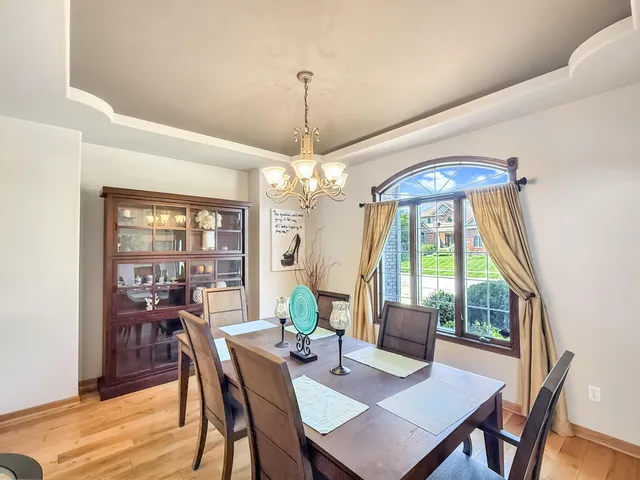 a view of a dining room with furniture wooden floor and chandelier