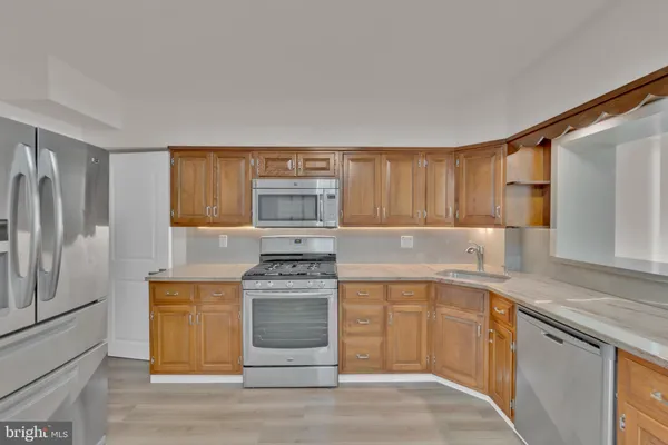 a kitchen with stainless steel appliances granite countertop a stove and a sink