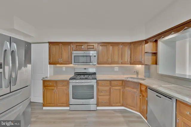 a kitchen with stainless steel appliances granite countertop a stove and a sink