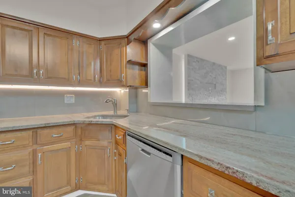 a kitchen with a sink cabinets and a window