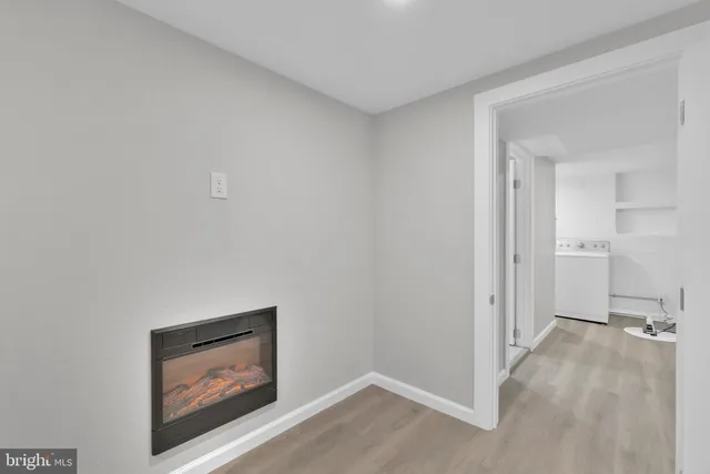 a bathroom with a sink vanity mirror and toilet