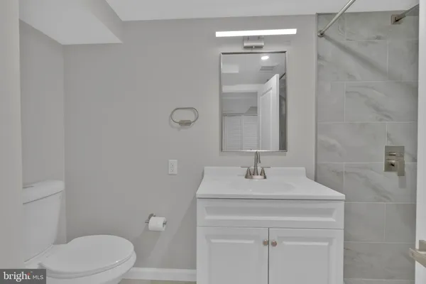 a bathroom with a sink vanity and a mirror