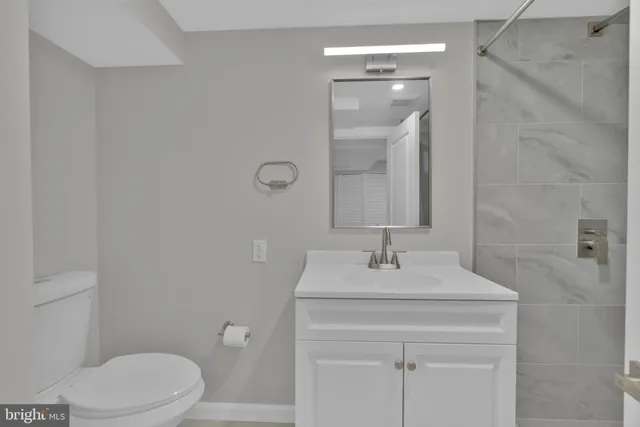 a bathroom with a sink vanity and a mirror