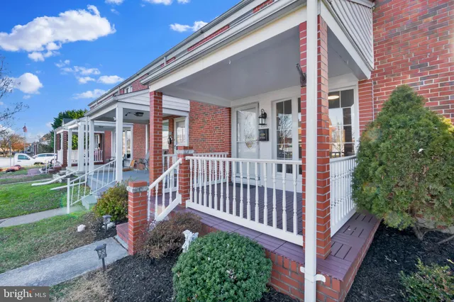 a view of a house with a small yard and floor to ceiling window
