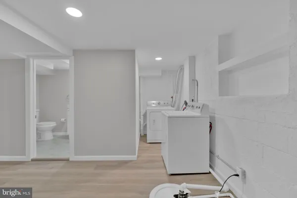 a view of a hallway with wooden shelves