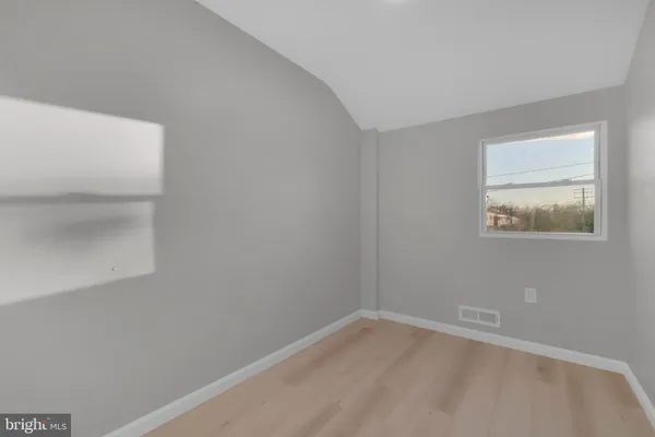 a view of a closet area with an empty room