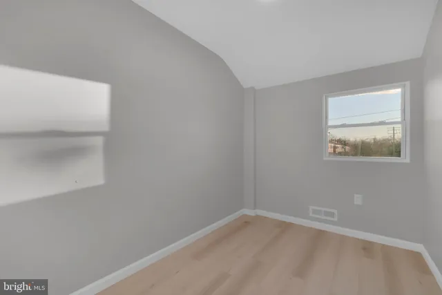 a view of a closet area with an empty room