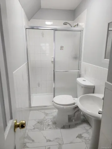 a bathroom with a toilet and a shower