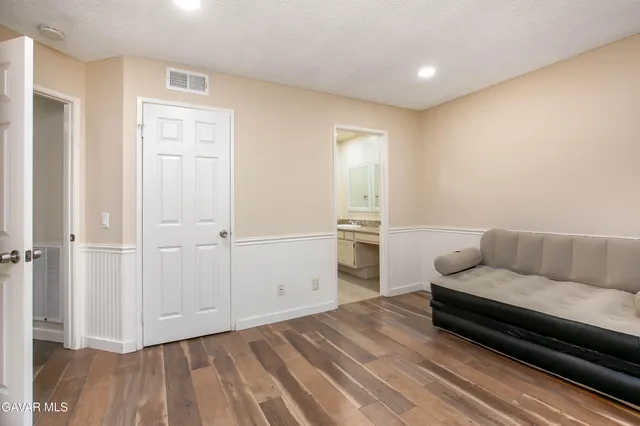 a living room with furniture and kitchen view
