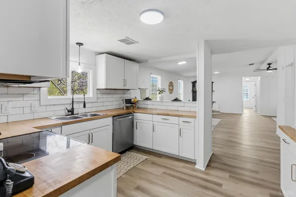 a kitchen with a sink cabinets and wooden floor