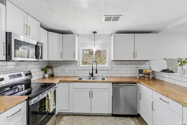 a kitchen with a sink stove and cabinets