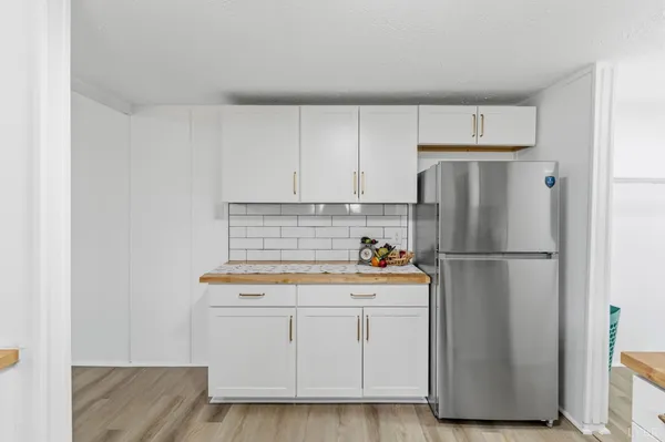 a white refrigerator freezer sitting inside of a kitchen