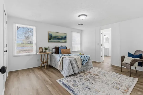 a bedroom with a bed and a couch