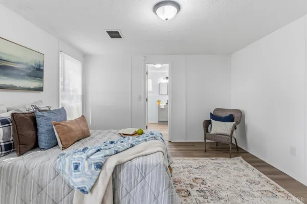 a bedroom with a bed and a chair