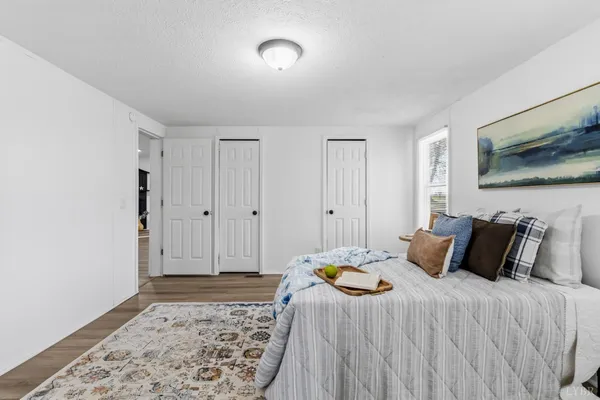 a bedroom with a bed and a flat screen tv