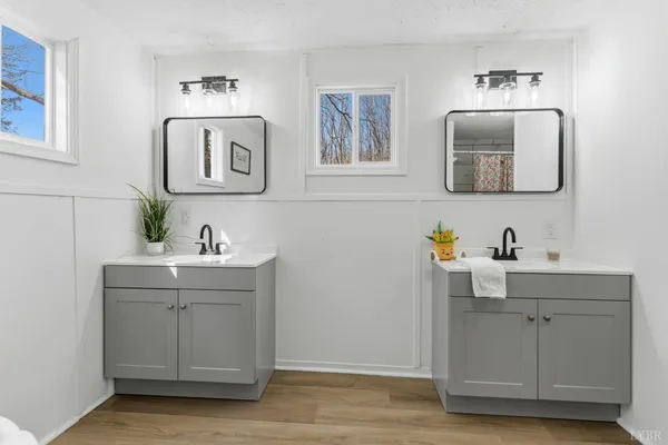 a bathroom with a double vanity sink mirror and
