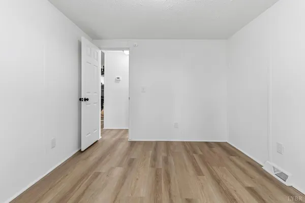 a view of a room with wooden floor