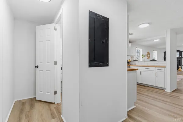 a view of a hallway with wooden floor and closet